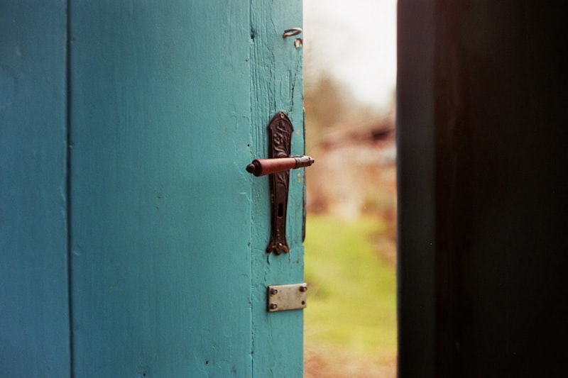 Blue wooden door slightly ajar